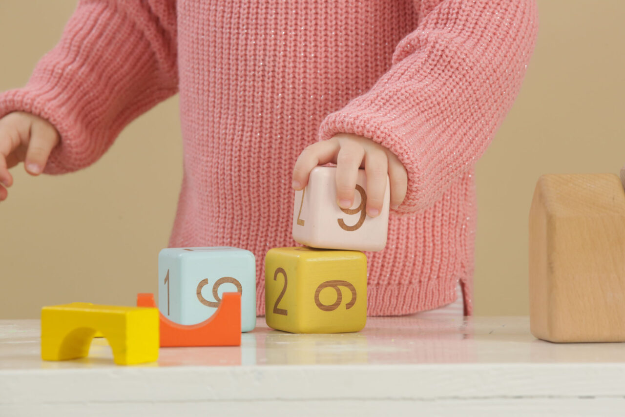 Close up of child playing with number blocks