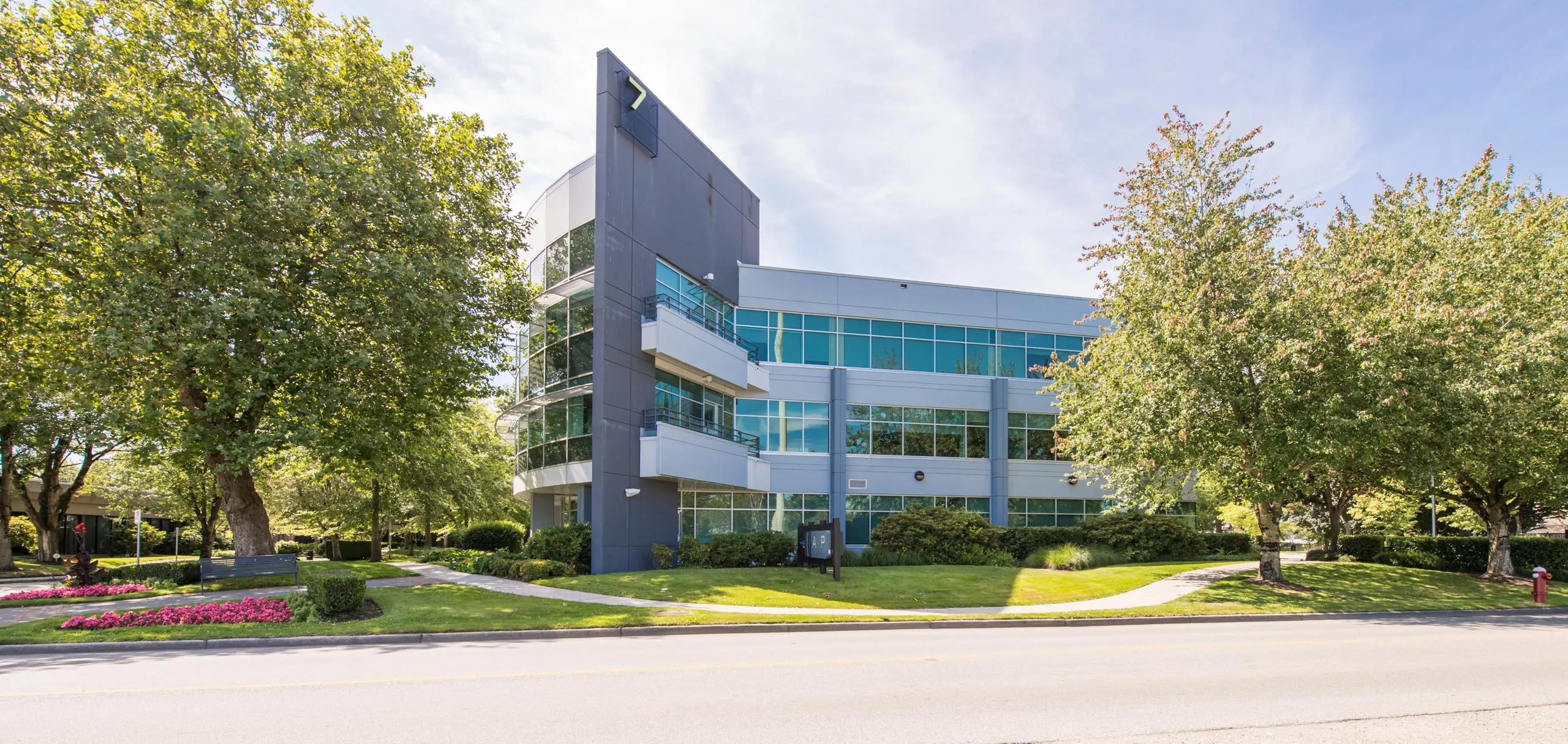 Exterior view of building 7 with lush greenery